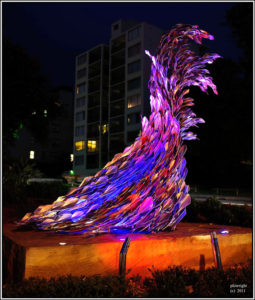 "Life Teeming – Life Teaming" Sculpture viewed at night with lights